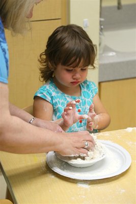 Grandmom helps with the mixing.