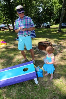 Ryan shows grandpop, Ed, the finer points of the game.