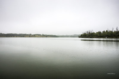 A foggy morning and a tranquil lake with a boat moored on the other side. Everything was quiet and it appears as if I was the only one about.
An image may be purchased at http://edward-peterson.artistwebsites.com/featured/just-a-boat-edward-peterson.html