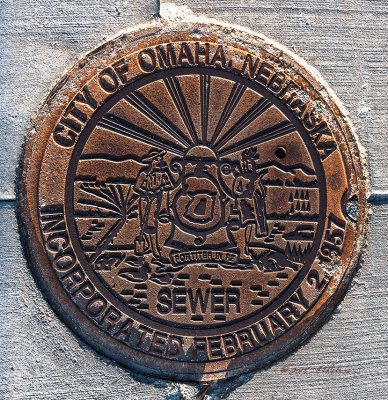 You see them every day you drive in a city. They are a key part of every city. But you don't often get to see all the talent that went into making a manhole cover. This does more than provide entry, it tells a story.

An image may be purchased at http://edward-peterson.artistwebsites.com/featured/omaha-history-edward-peterson.html
