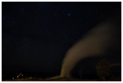 Old Faithful steaming at night