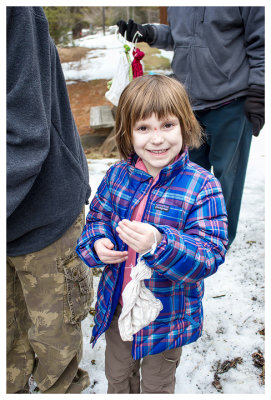 Norah holding a bird in a bag