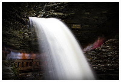 Visitors moving under the falls