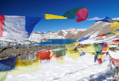 prayer flags in front of Tilicho lake