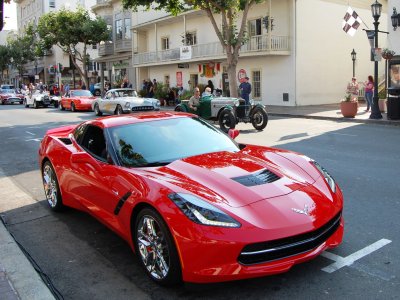 2014 Corvette in red serving as pace car for some historic classics