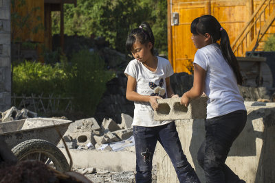 girls helping mom to build a house 
