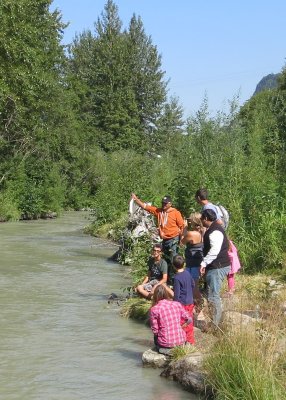 People watching Uncle Carl grab a salmon with his bare hands