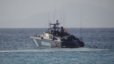 Customs launch checking closely every yacht anchored off Es Cavall den Borras beach