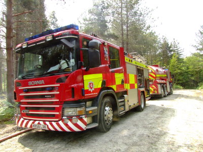 Fire Engine and water bowser, on location,in a wood.