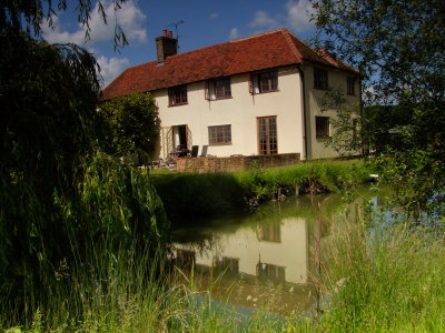 Cesslands  Farmhouse  reflected  in  the  moat .