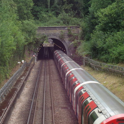 A  Central  Line  tube train , leaving  a  tunnel.