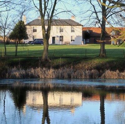 C17th century  Magdalen  Laver  Hall , reflected  in  pond