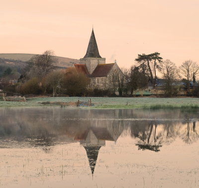 C. 14th century St. Andrew's  Parish  Church , reflecting  in  recent  floodwaters.