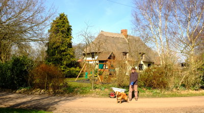 Richard  with  Amber  the  Collie , outside  the  thatched  cottage.