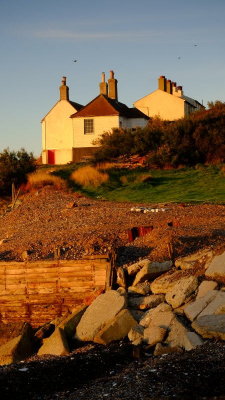 Old  coastguard  cottages  and  anti--erosion  barriers.