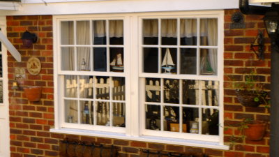 Fencing  reflected  in  cottage  windows.