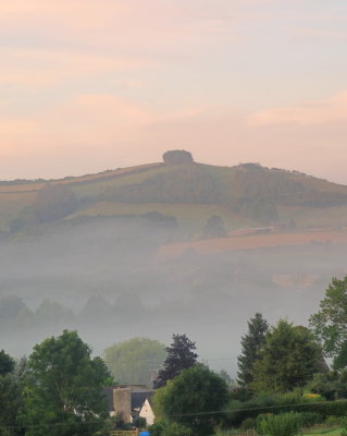 Clunbury  Hill  rises  above  a  misty dawn  in  Aston.