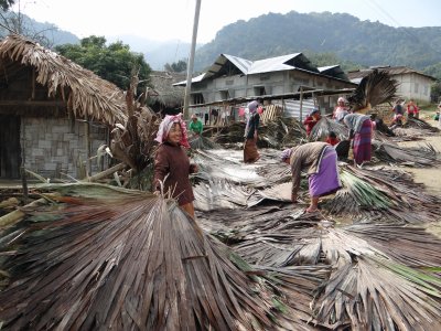 Miyuong women building roofs (community effort)
