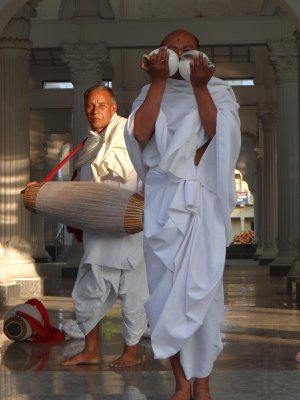 Priests playing a conch and a drum