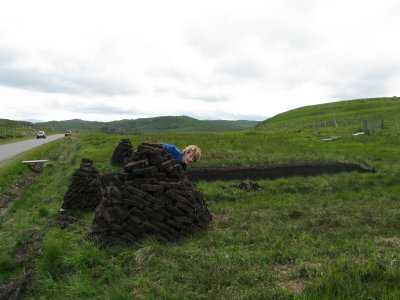 a good peat stack waiting to be collected - with some nutter peaking out from behind it