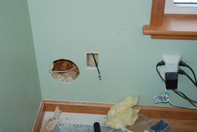 Cutting the inside hole through the drywall.