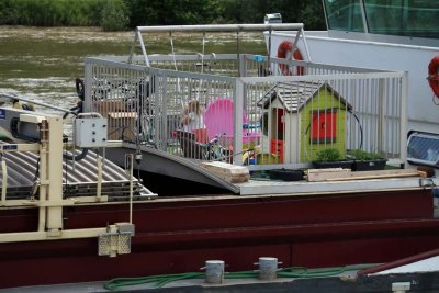 CHILDREN PLAYING ON DECK OF FAMILY BOAT