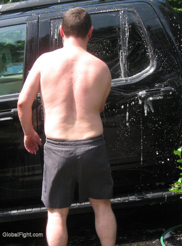 bearish husky man washing truck.jpg