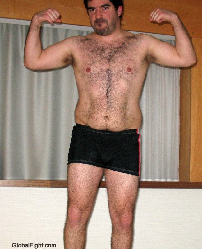 hairy hunk flexing his arms.jpg