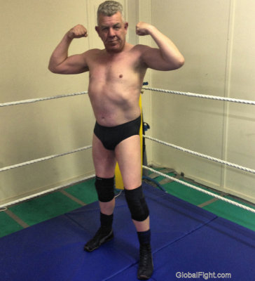 tough muscular silverdaddie flexing arms.jpg