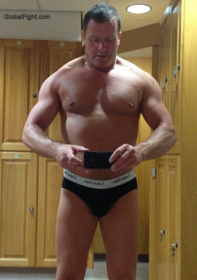 hot older muscledad posing lockerroom gym.jpg