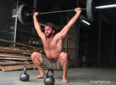 very hot man lifting weights.jpg
