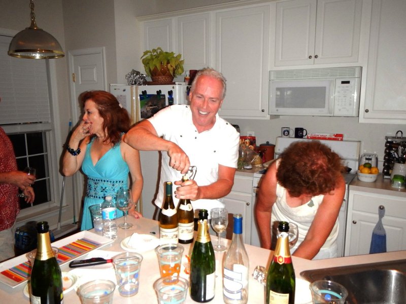 Doug prepares to pop the cork; all eyes are on him.