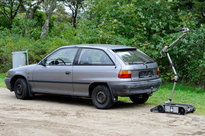 The small iRobot examines the car