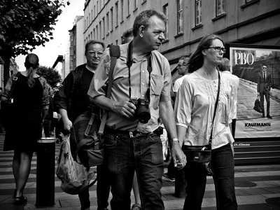 Street photographer holding hand