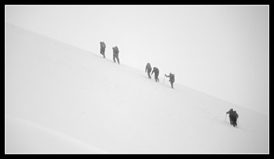Mountaineers on the Opposite Ridge Climb into the Clouds