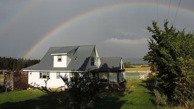 Rainbow over farmhouse