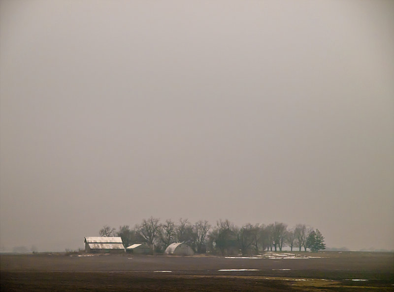 Farm in  early morning fog