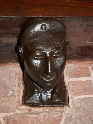 Wood carving of CCC boy as mantel brace on right