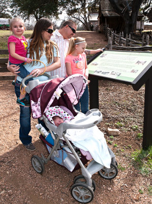 Family reading information before hiking the trail