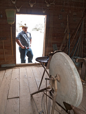 Cowboy looking at grinding wheel