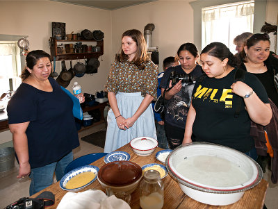 Courtny, Park Volenteer, discussing cooking methods in farm kitchen