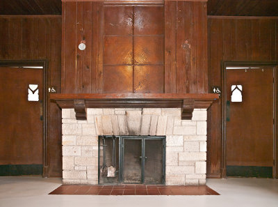 Entry/reception area fireplace (note abstract M and W on restroom doors)