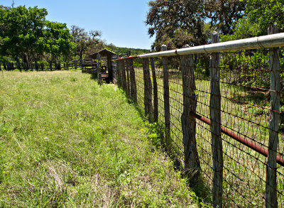Looking down fence to cattle dipping vat