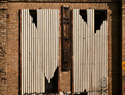 Broken tin over windows, Austin, TX