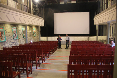 Interior of the theater. The hard wooden chairs look less comfortable than theater seats today.