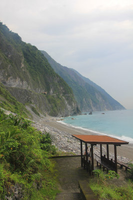 Small roofed structure on the beach below.