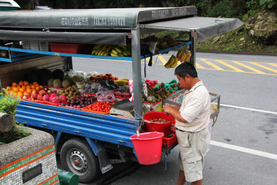 A fruit vendor with his truck were, nearby.