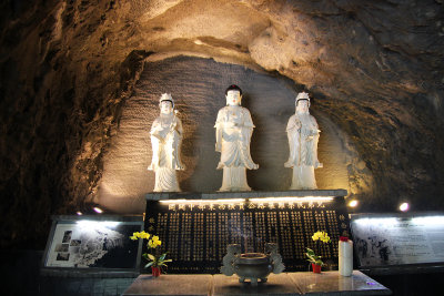 Three Buddhist statues on the way to the shrine.