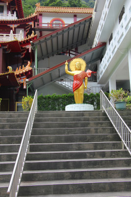 Buddhist statue at the top of the temple steps.