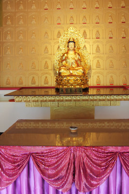 A third golden figure on the first floor of the temple.